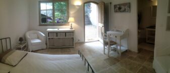 chambre typée provençale avec porte ouverte sur extérieur