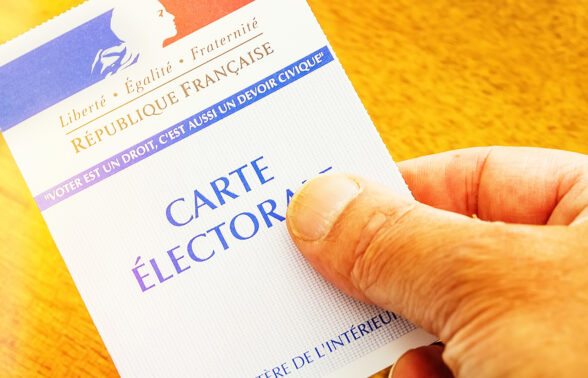 photo d'une carte électorale tenue à la main sur fond jaune - Agrandir l'image, fenêtre modale